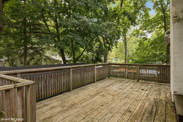 a balcony with view of trees in the background