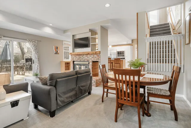 a living room with furniture a flat screen tv and windows