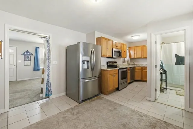 a kitchen with stainless steel appliances granite countertop a refrigerator oven a sink and dishwasher