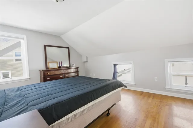 a bedroom with a bed and a tv on the dresser