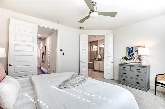 a bedroom with a bed and a dresser