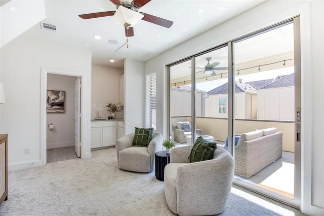 a bedroom with furniture and a chandelier fan