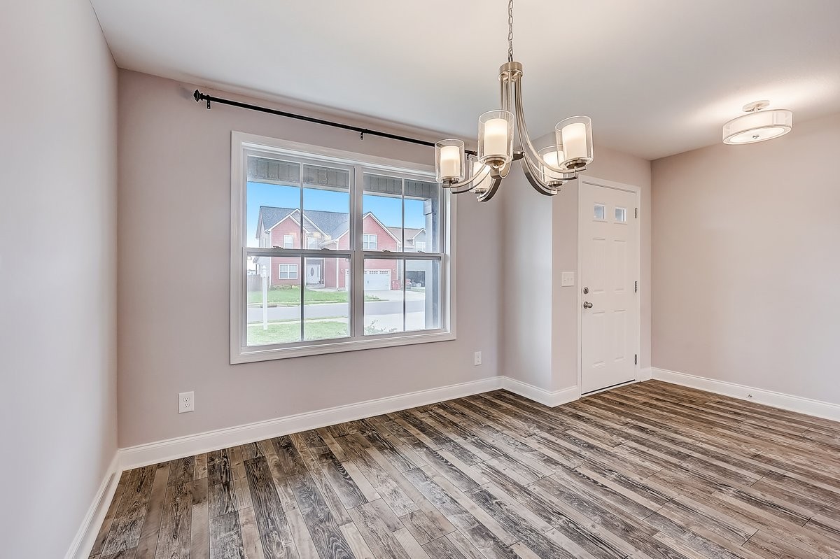 414 Andean Court Clarksville, TN 37040 - Photo 5 of 26 a view of a room with wooden floor a ceiling fan and a window
