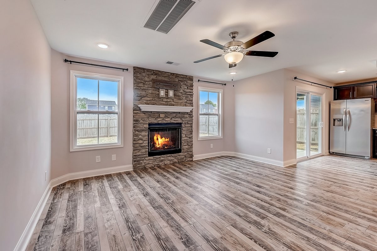 414 Andean Court Clarksville, TN 37040 - Photo 7 of 26 a view of empty room with wooden floor fireplace and a window