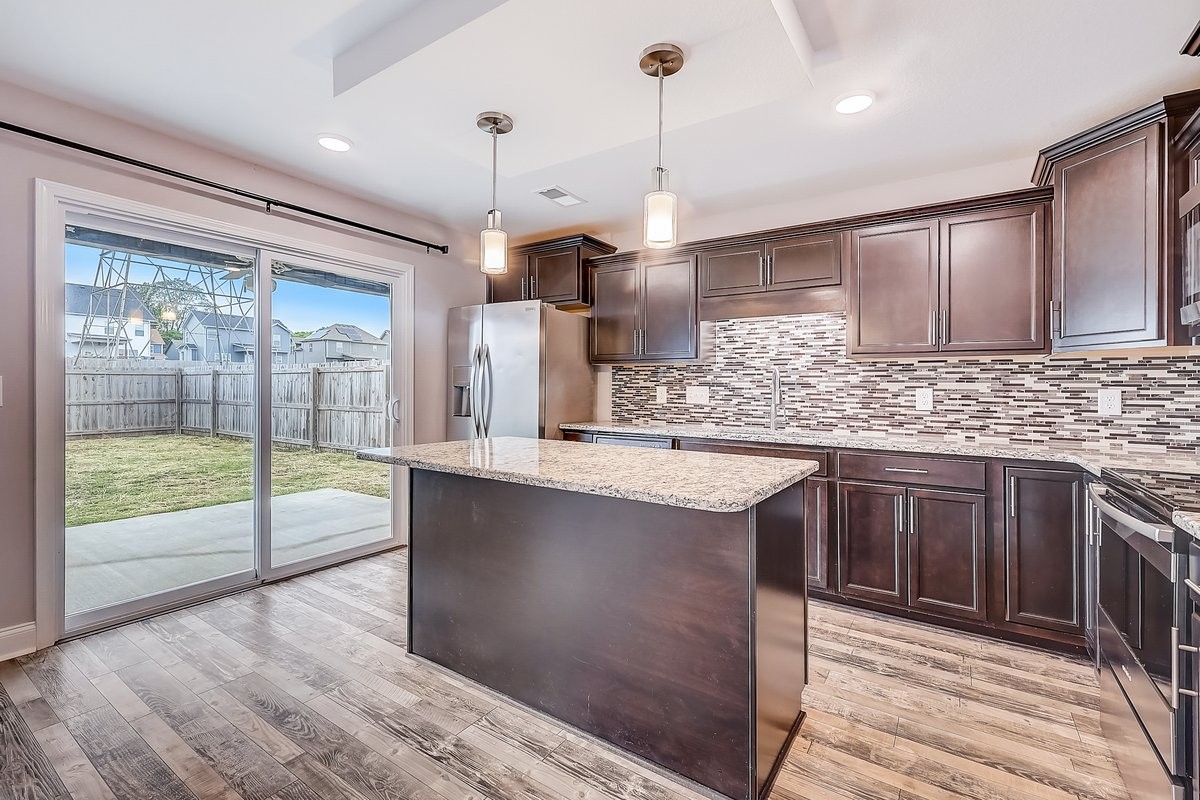 414 Andean Court Clarksville, TN 37040 - Photo 9 of 26 a kitchen with stainless steel appliances granite countertop a sink a stove and a wooden floors