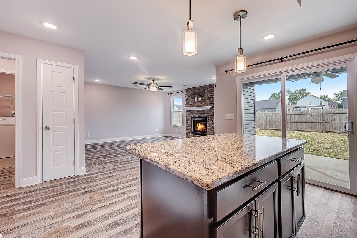 414 Andean Court Clarksville, TN 37040 - Photo 10 of 26 a kitchen with kitchen island a counter top space wooden floor and a ceiling fan