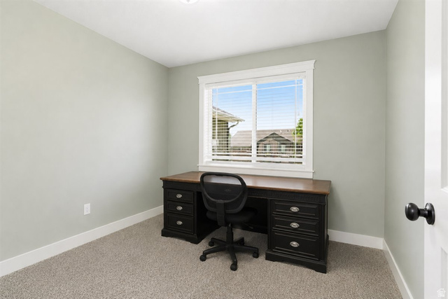 772 East 600 South Preston, ID 83263 - Photo 14 of 35 Neutral-toned room featuring a large window with white blinds, light gray walls, white trim, and carpeted flooring