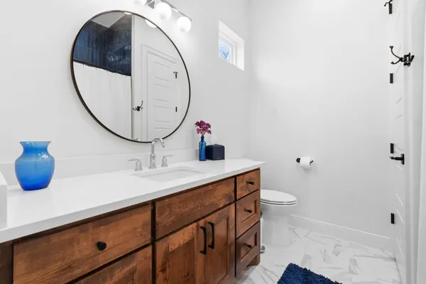 a view of a house with a big yard and large trees