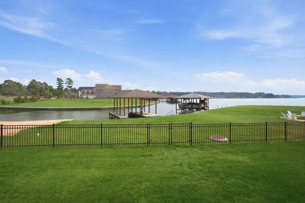 a large kitchen with kitchen island a sink a stove and cabinets