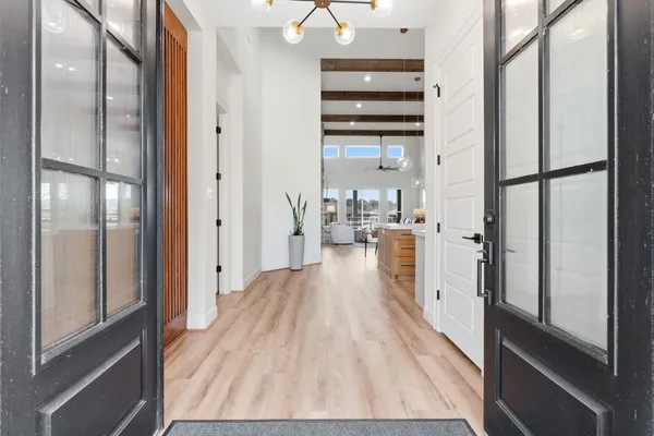 a kitchen with stainless steel appliances kitchen island granite countertop a table chairs in it and wooden floors