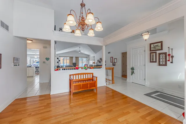 a view of a room with wooden floor and lots of windows