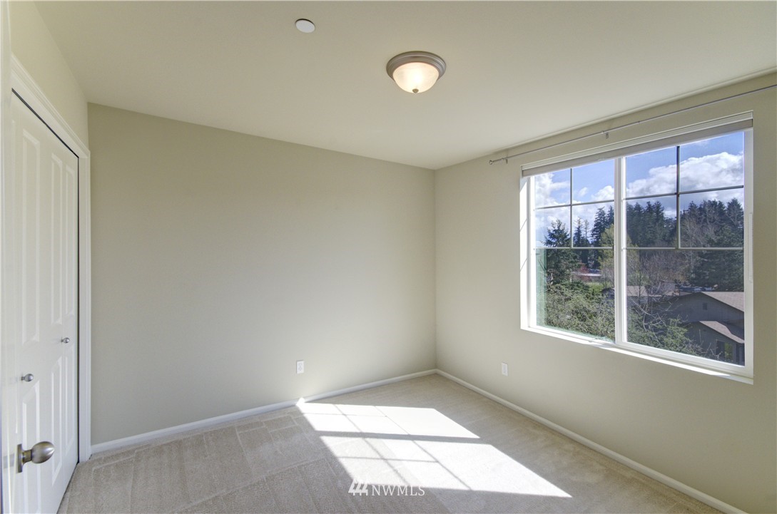 10715 Ross Road, Unit A Bothell, WA 98011 - Photo 14 of 20 a view of an empty room with a window