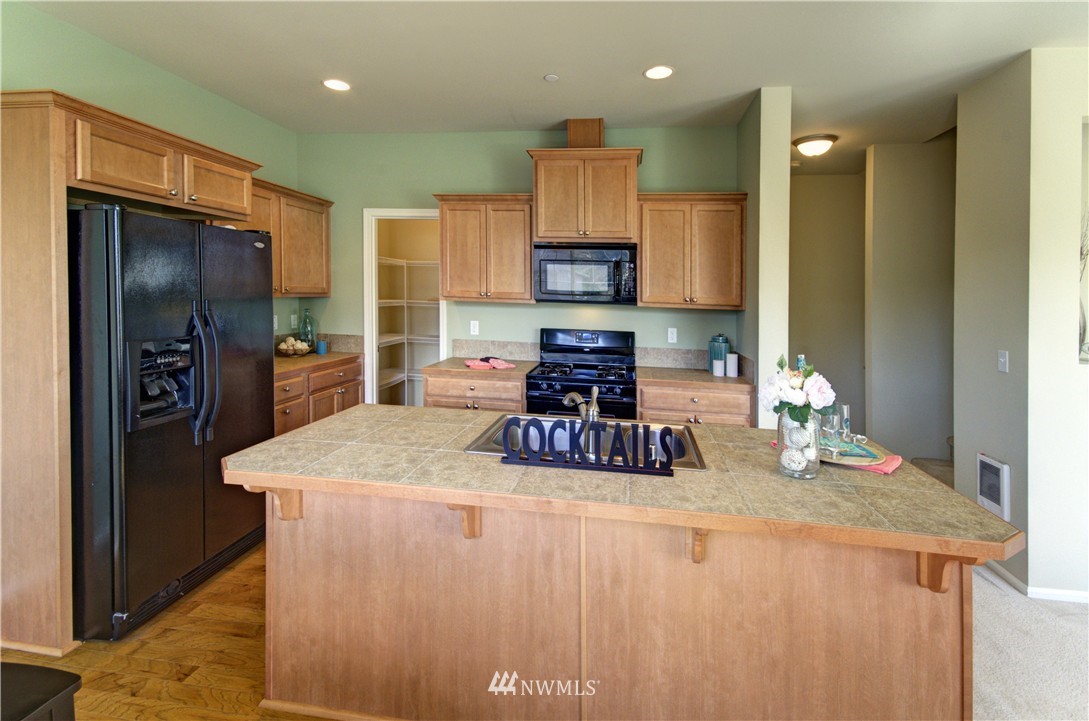 10715 Ross Road, Unit A Bothell, WA 98011 - Photo 8 of 20 a kitchen with a refrigerator a stove and a sink