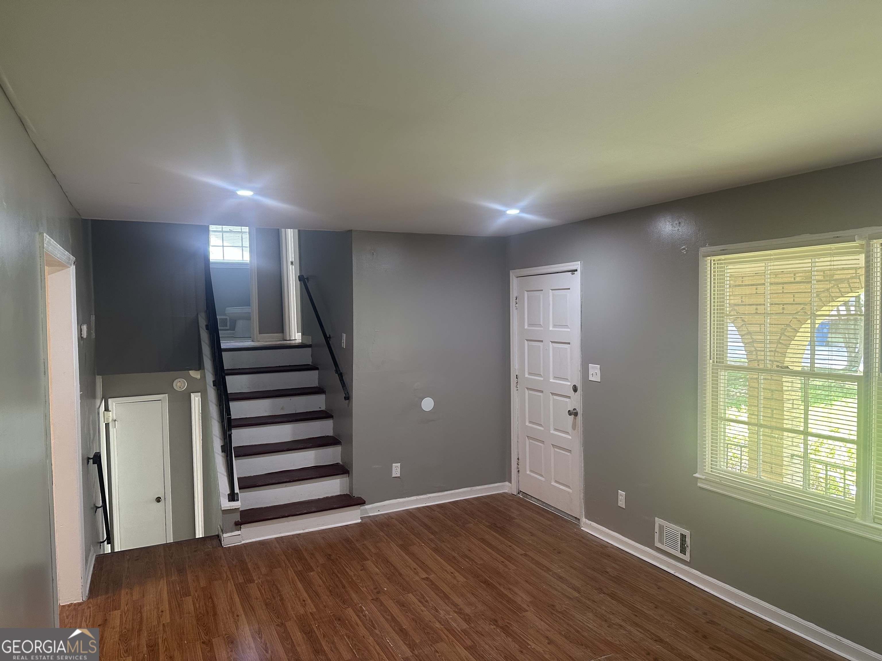 273 Fennel Way Southwest Atlanta, GA 30331 - Photo 11 of 20 a view of an empty room with wooden floor and windows