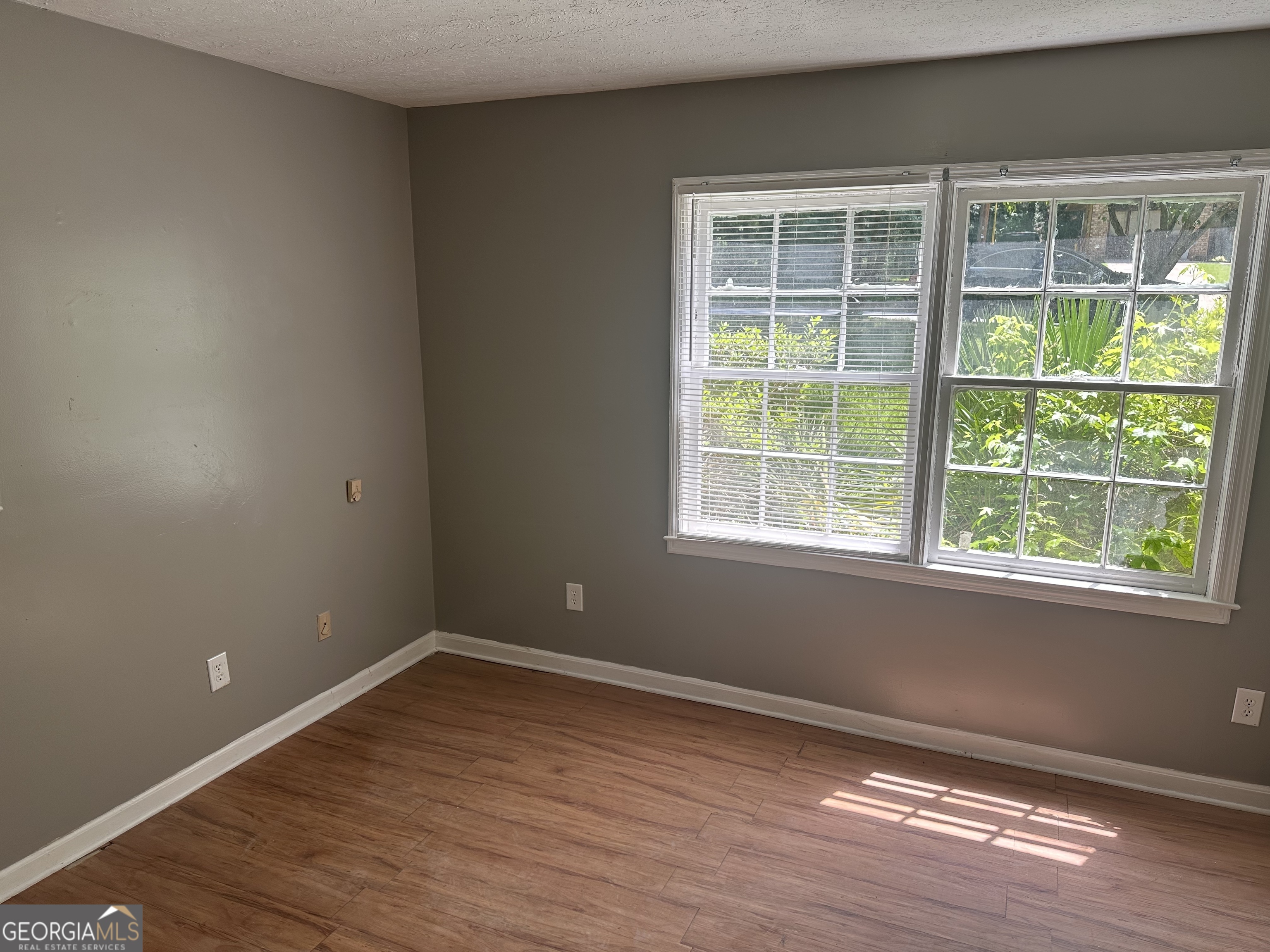 273 Fennel Way Southwest Atlanta, GA 30331 - Photo 16 of 20 a view of an empty room with wooden floor and a window