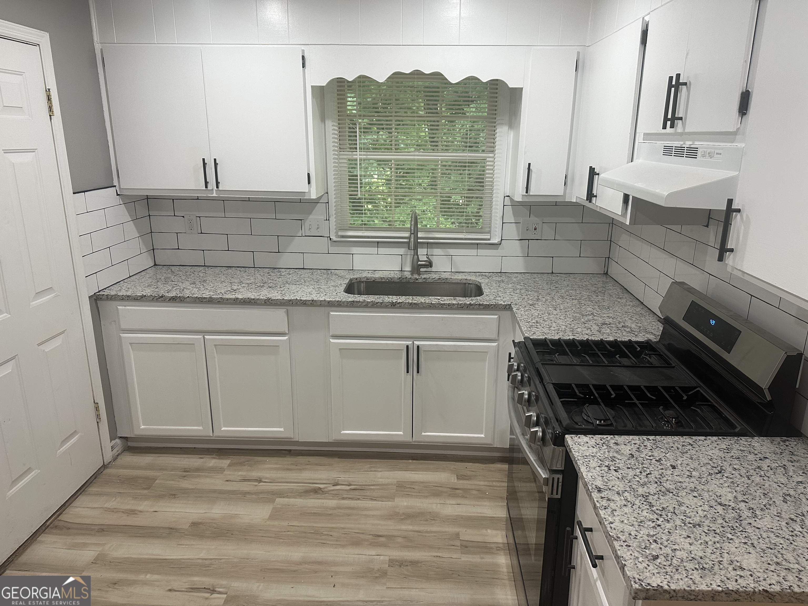 273 Fennel Way Southwest Atlanta, GA 30331 - Photo 8 of 20 a kitchen with stainless steel appliances granite countertop a stove a sink and a microwave