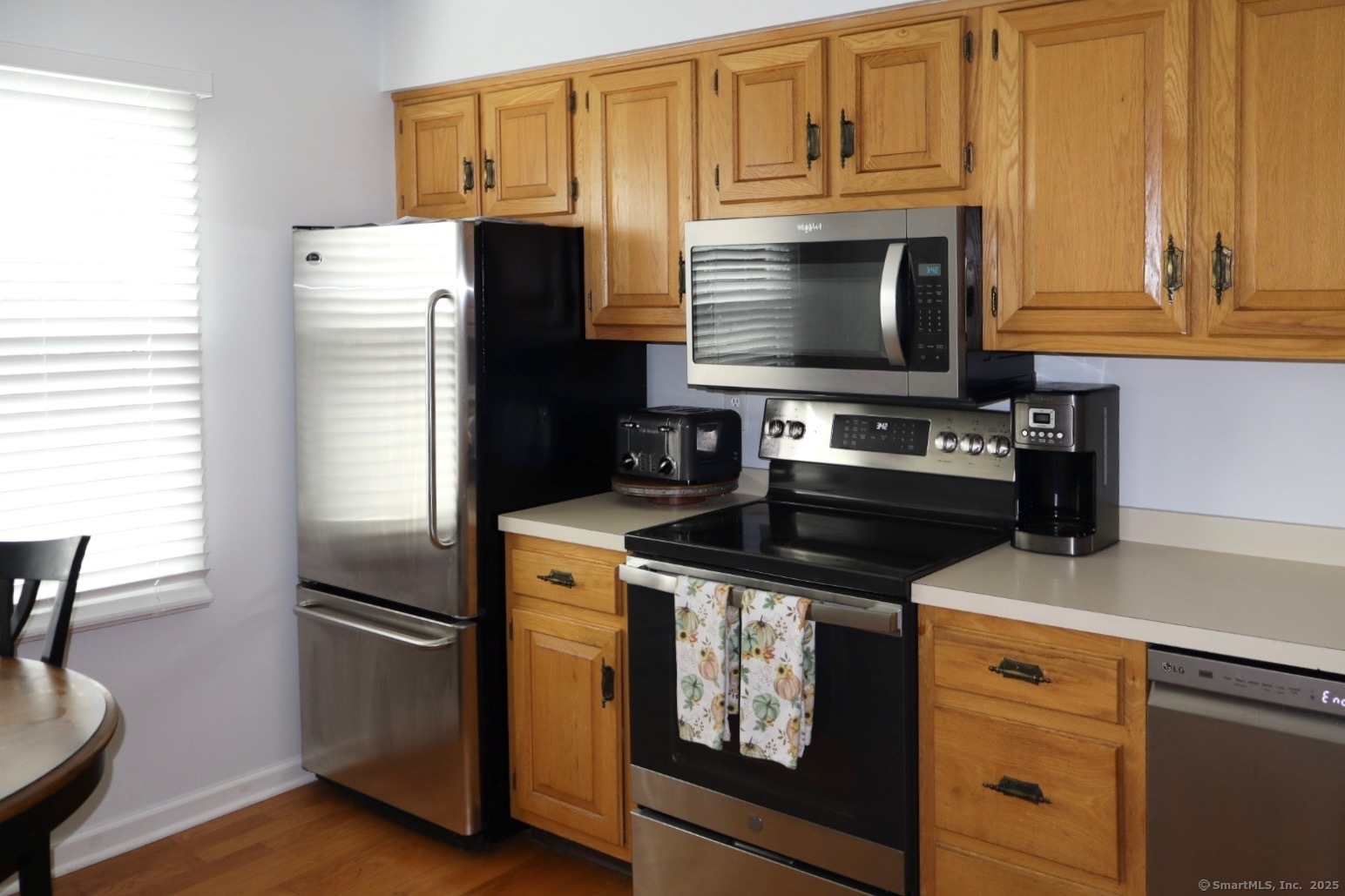 33 Stillmeadow Circle, Unit 33 Monroe, CT 06468 - Photo 13 of 14 a kitchen with stainless steel appliances granite countertop a refrigerator stove and microwave