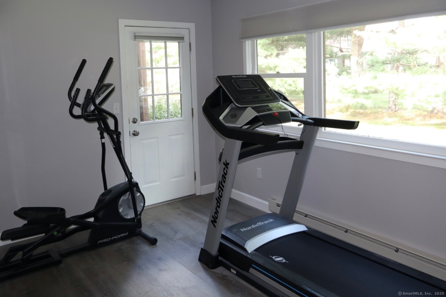 33 Stillmeadow Circle, Unit 33 Monroe, CT 06468 - Photo 14 of 14 a room with gym equipment on wooden floor and windows