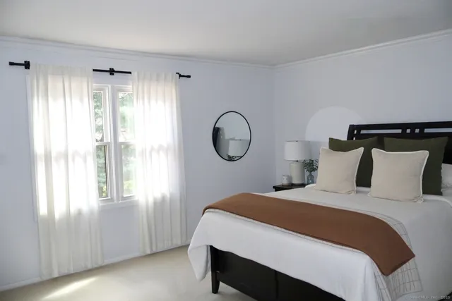 a bedroom with a large bed and a window