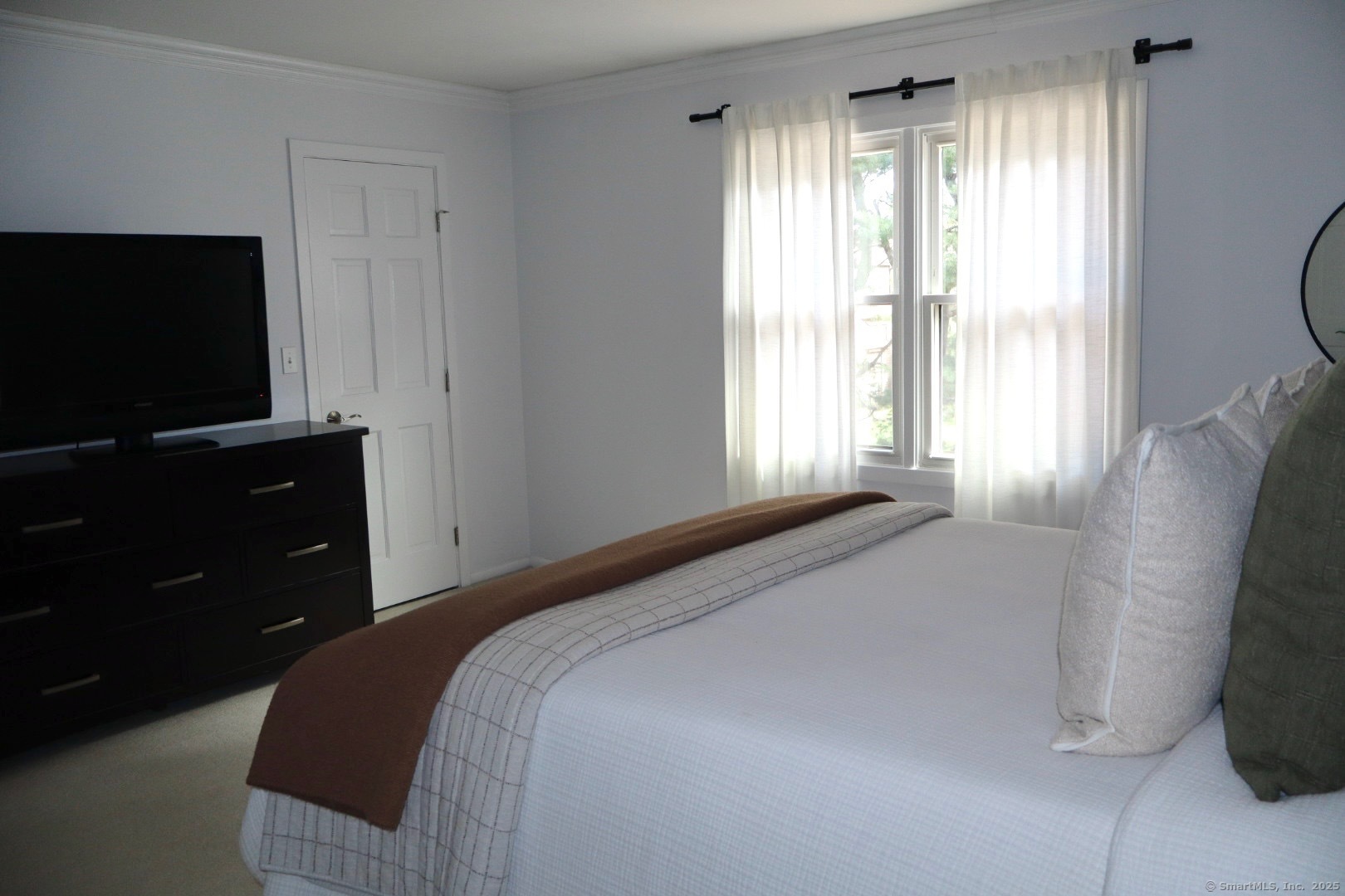 33 Stillmeadow Circle, Unit 33 Monroe, CT 06468 - Photo 7 of 14 a bedroom with a bed and a flat tv screen on dresser