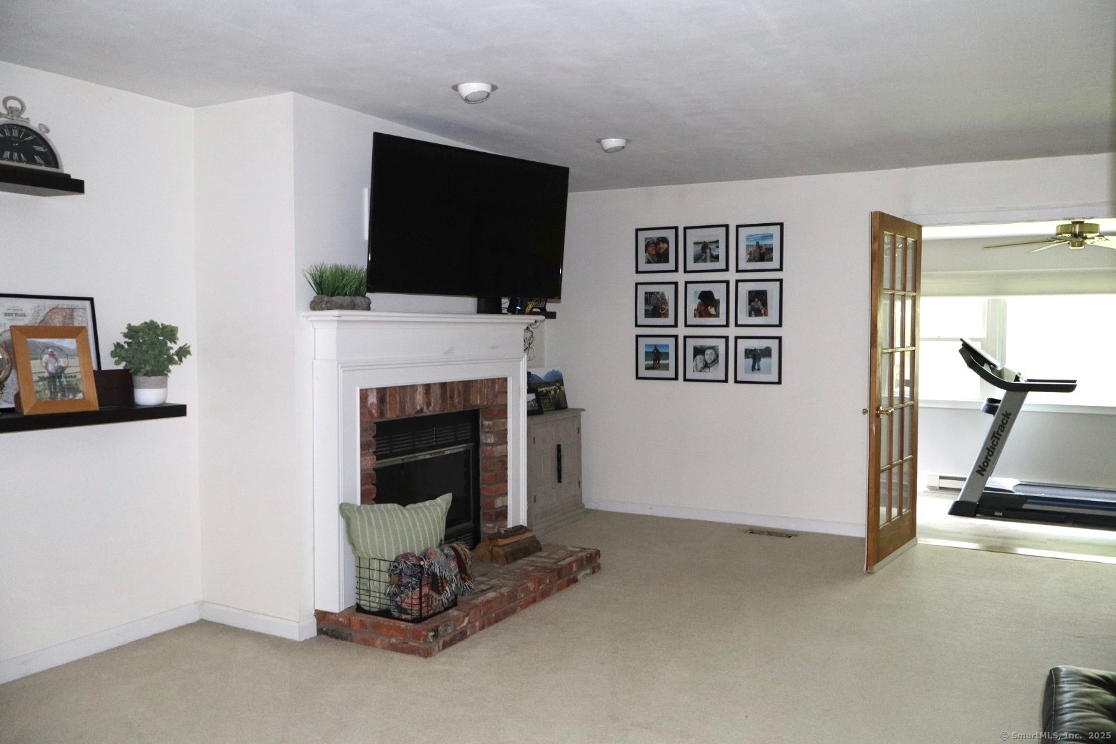 33 Stillmeadow Circle, Unit 33 Monroe, CT 06468 - Photo 10 of 14 a living room with furniture a flat screen tv and a fireplace