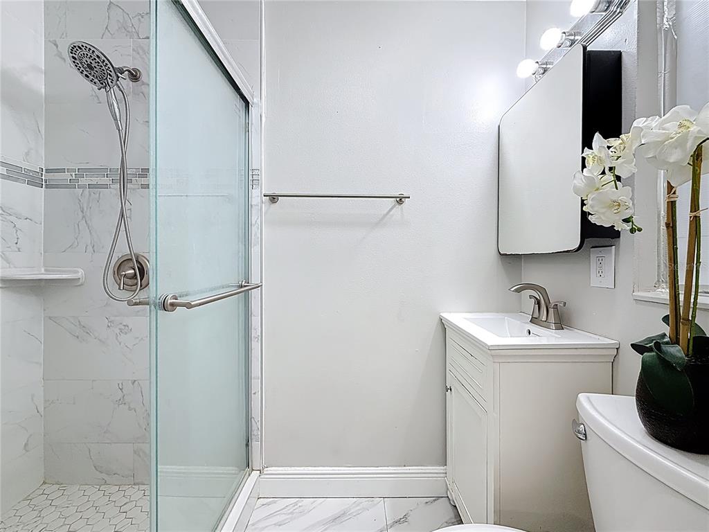 1614 Braund Avenue Clearwater, FL 33756 - Photo 14 of 29 a bathroom with a sink toilet and shower