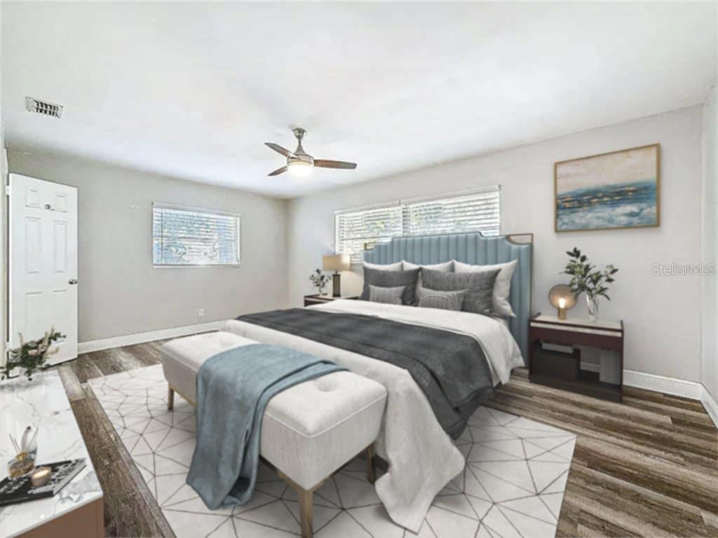 1614 Braund Avenue Clearwater, FL 33756 - Photo 16 of 29 a bed room with a bed and a chandelier