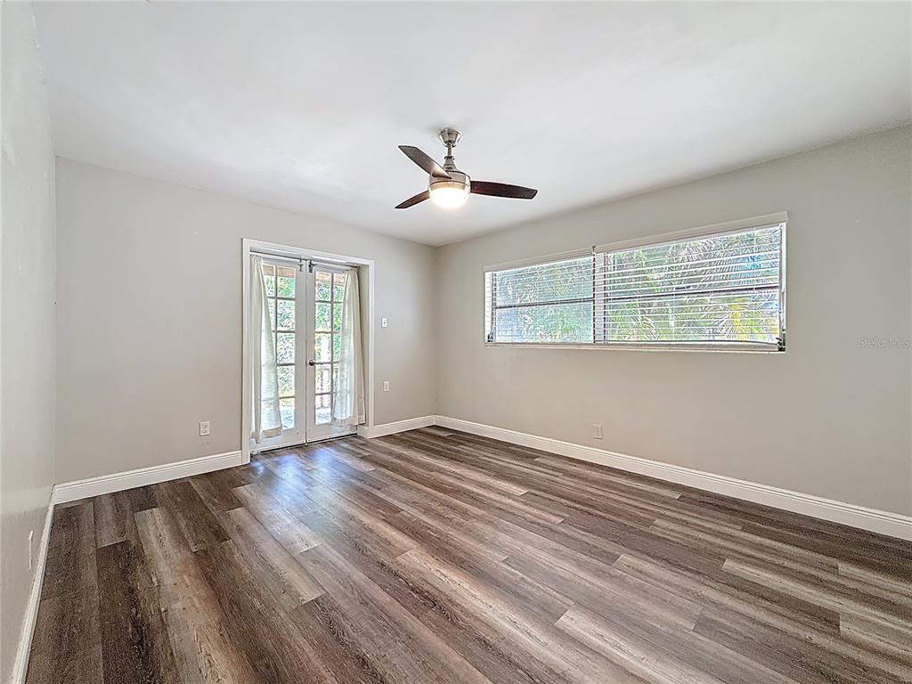 1614 Braund Avenue Clearwater, FL 33756 - Photo 17 of 29 a view of an empty room with wooden floor and a window