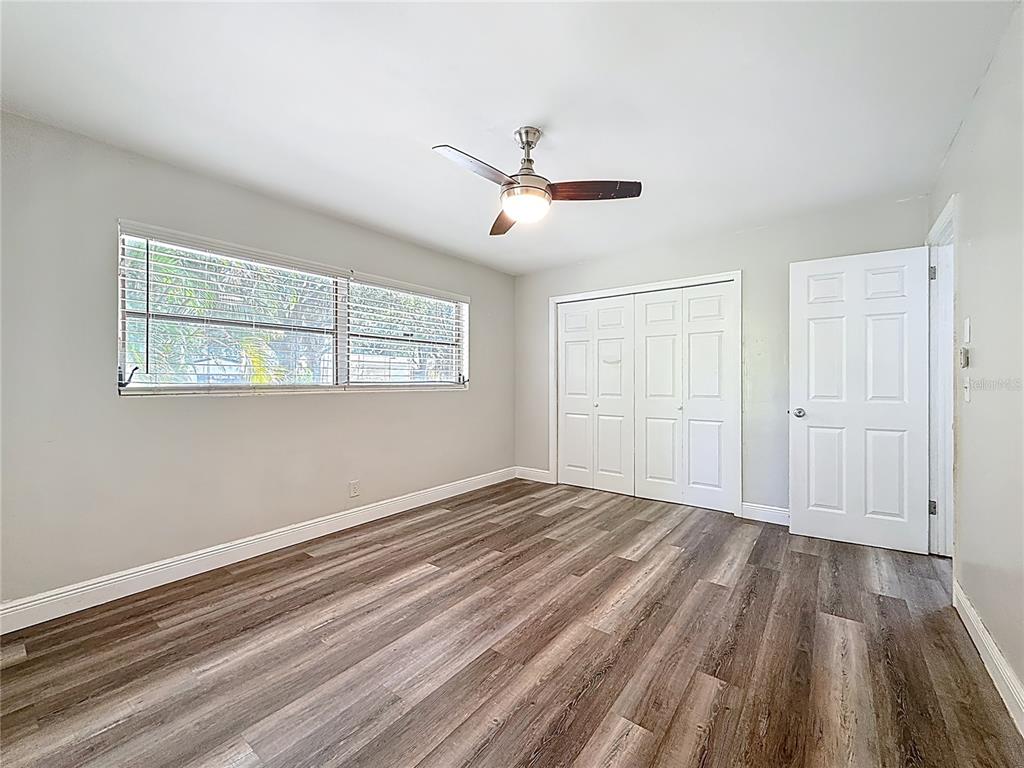 1614 Braund Avenue Clearwater, FL 33756 - Photo 18 of 29 a view of empty room with wooden floor and fan