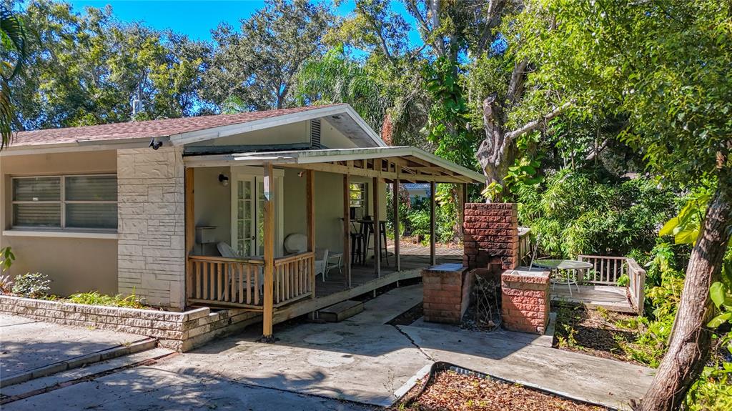 1614 Braund Avenue Clearwater, FL 33756 - Photo 26 of 29 a view of a patio with table and chairs under an umbrella