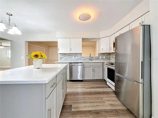 a hallway with a sink and wooden floor