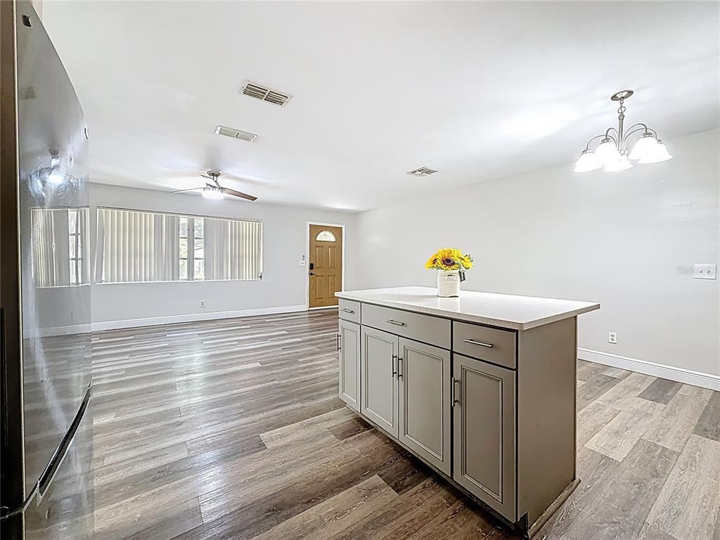 1614 Braund Avenue Clearwater, FL 33756 - Photo 7 of 29 a hallway with a sink and wooden floor