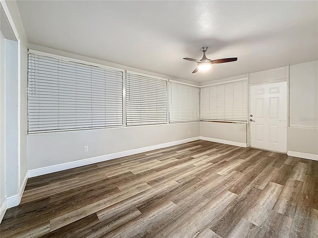 1614 Braund Avenue Clearwater, FL 33756 - Photo 9 of 29 a view of empty room with wooden floor and fan