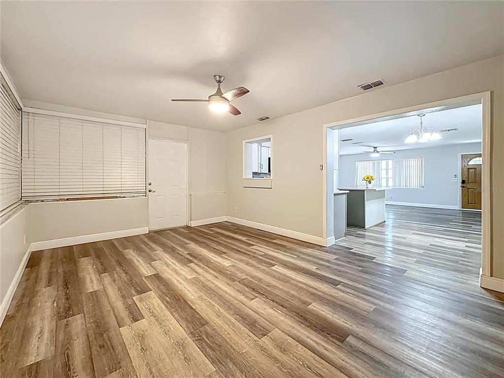 1614 Braund Avenue Clearwater, FL 33756 - Photo 10 of 29 a view of empty room with wooden floor and fan