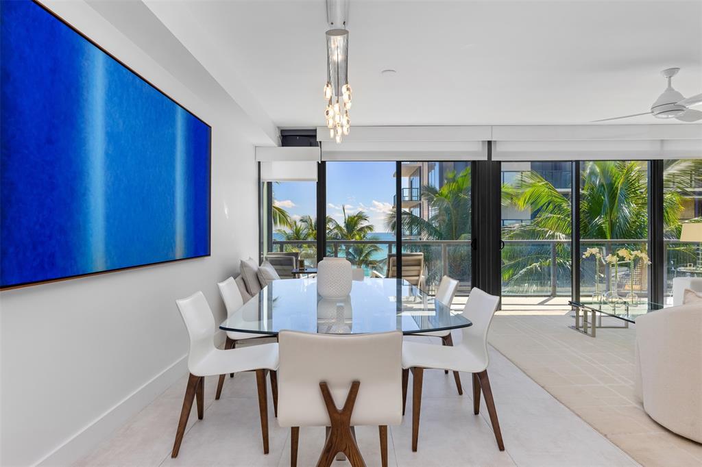 2101 South Surf Road, Unit 4C Hollywood, FL 33019 - Photo 13 of 55 a view of a dining room with furniture large windows and wooden floor