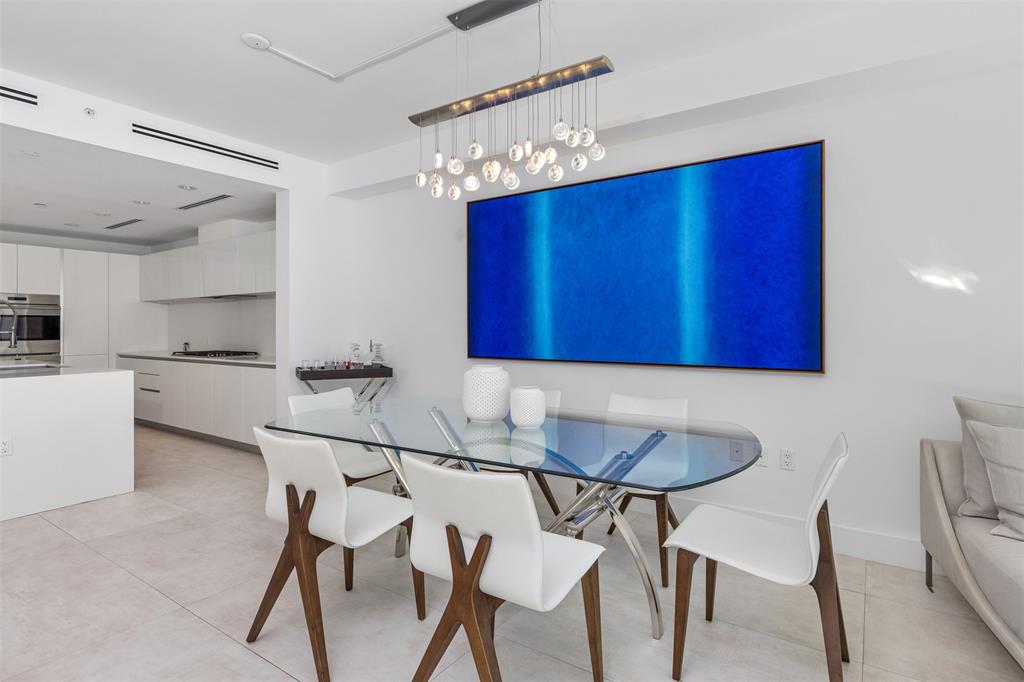 2101 South Surf Road, Unit 4C Hollywood, FL 33019 - Photo 16 of 55 a kitchen with granite countertop a dining table chairs and a refrigerator