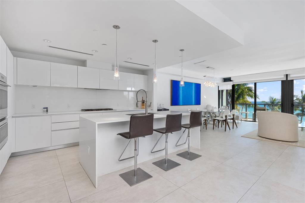 2101 South Surf Road, Unit 4C Hollywood, FL 33019 - Photo 24 of 55 a kitchen with cabinets and chairs