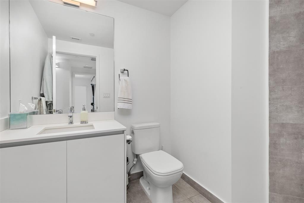 2101 South Surf Road, Unit 4C Hollywood, FL 33019 - Photo 33 of 55 a bathroom with a toilet sink and mirror