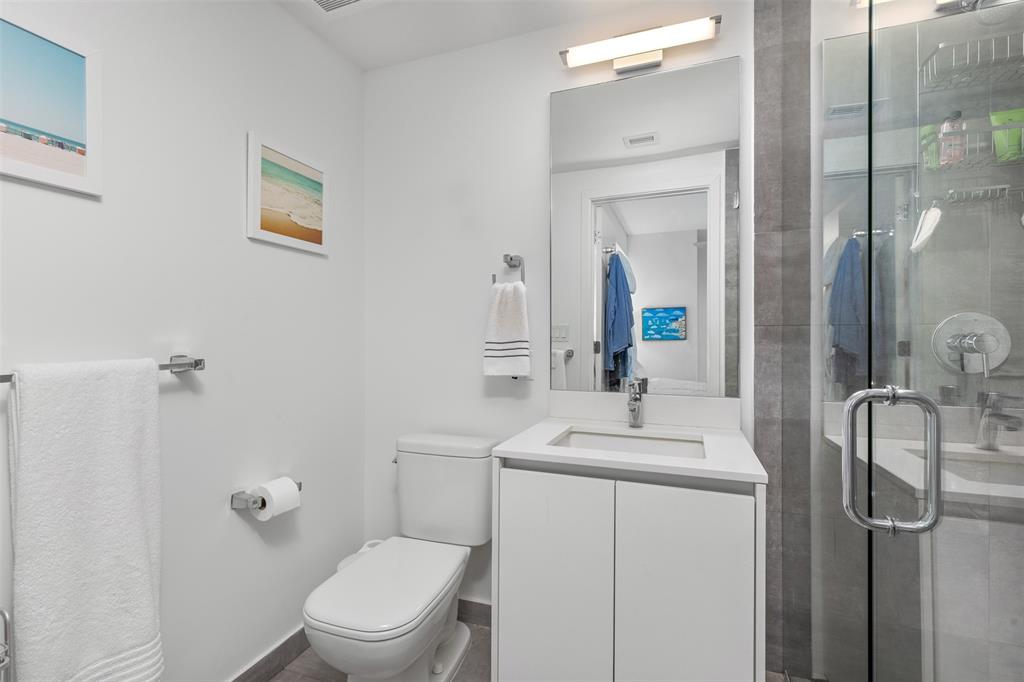 2101 South Surf Road, Unit 4C Hollywood, FL 33019 - Photo 36 of 55 a bathroom with a toilet sink vanity and mirror
