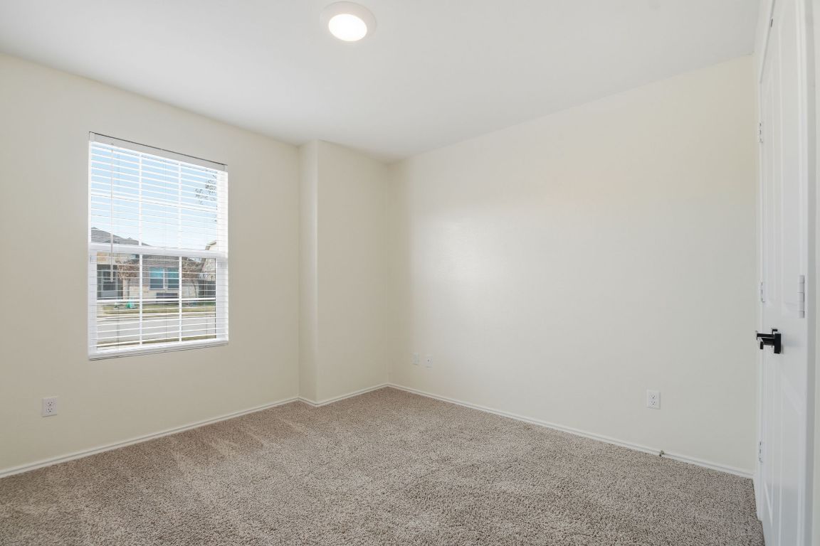 287 George Neggan Lane Bastrop, TX 78602 - Photo 12 of 26 an empty room with windows