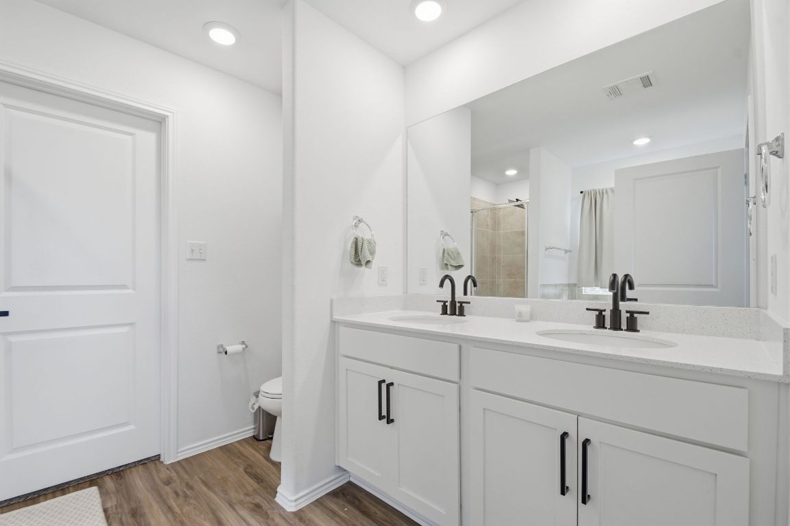287 George Neggan Lane Bastrop, TX 78602 - Photo 20 of 26 a bathroom with a sink a toilet a shower and a mirror