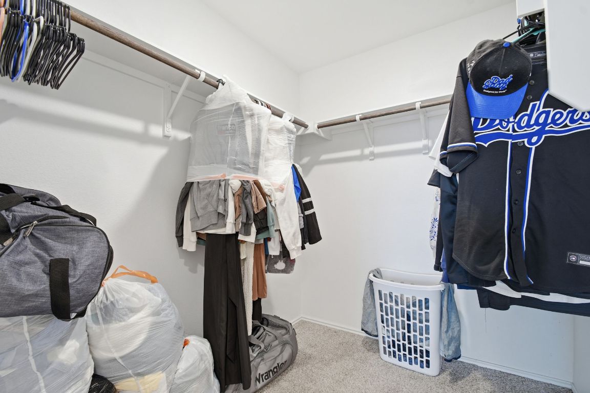 287 George Neggan Lane Bastrop, TX 78602 - Photo 22 of 26 a view of walk in closet with clothes and shoes