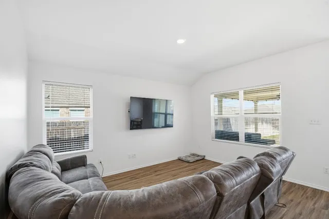 a bedroom with a bed couch and window