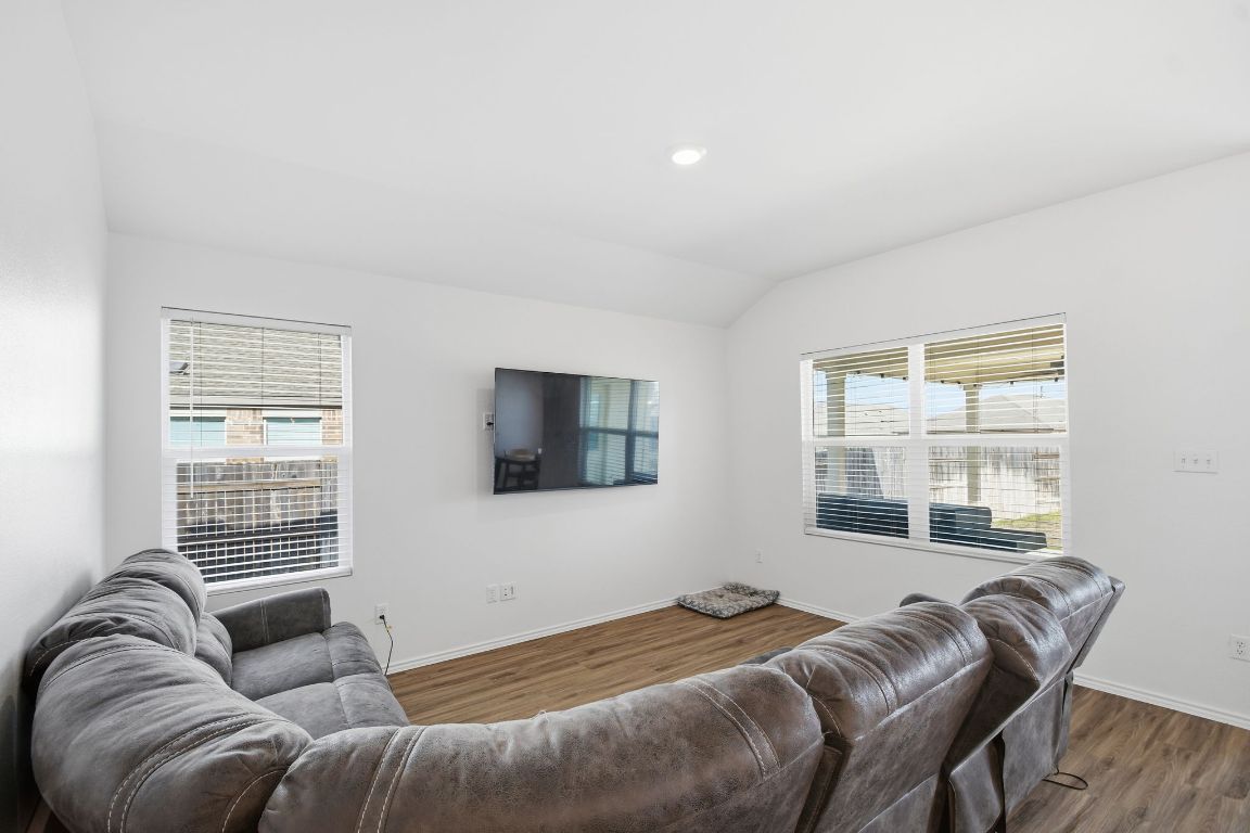 287 George Neggan Lane Bastrop, TX 78602 - Photo 4 of 26 a bedroom with a bed couch and window