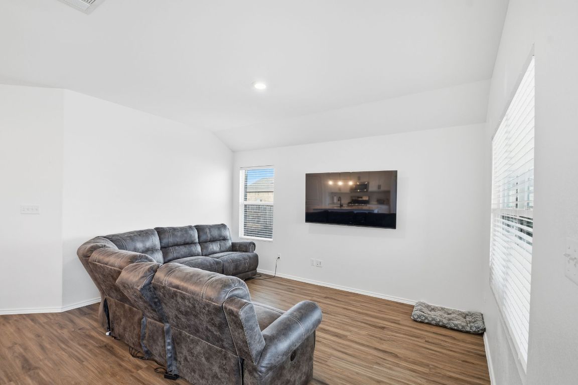 287 George Neggan Lane Bastrop, TX 78602 - Photo 5 of 26 a living room with furniture and a flat screen tv