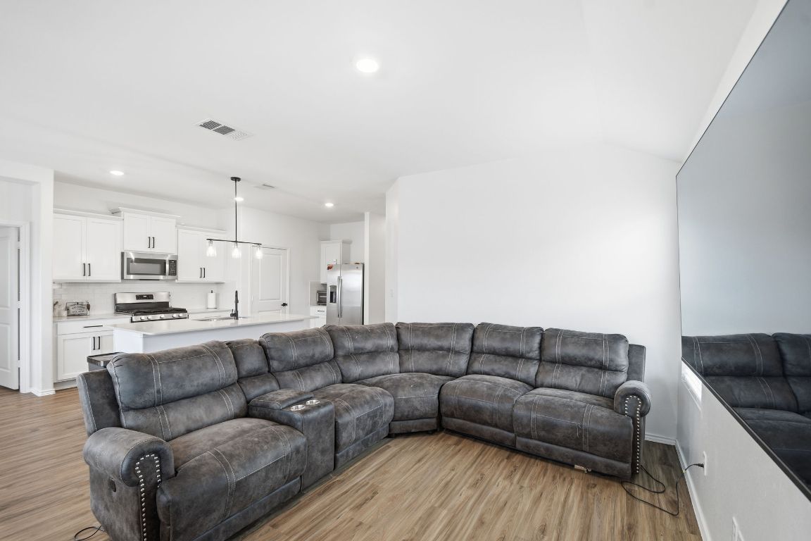 287 George Neggan Lane Bastrop, TX 78602 - Photo 6 of 26 a living room with furniture white walls and kitchen view