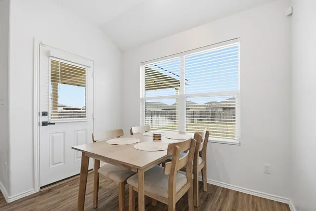 a view of a dining room with furniture and windows
