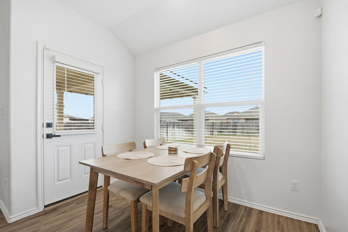 287 George Neggan Lane Bastrop, TX 78602 - Photo 8 of 26 a view of a dining room with furniture and windows