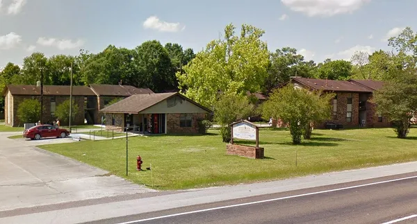 a view of a house with backyard and sitting area