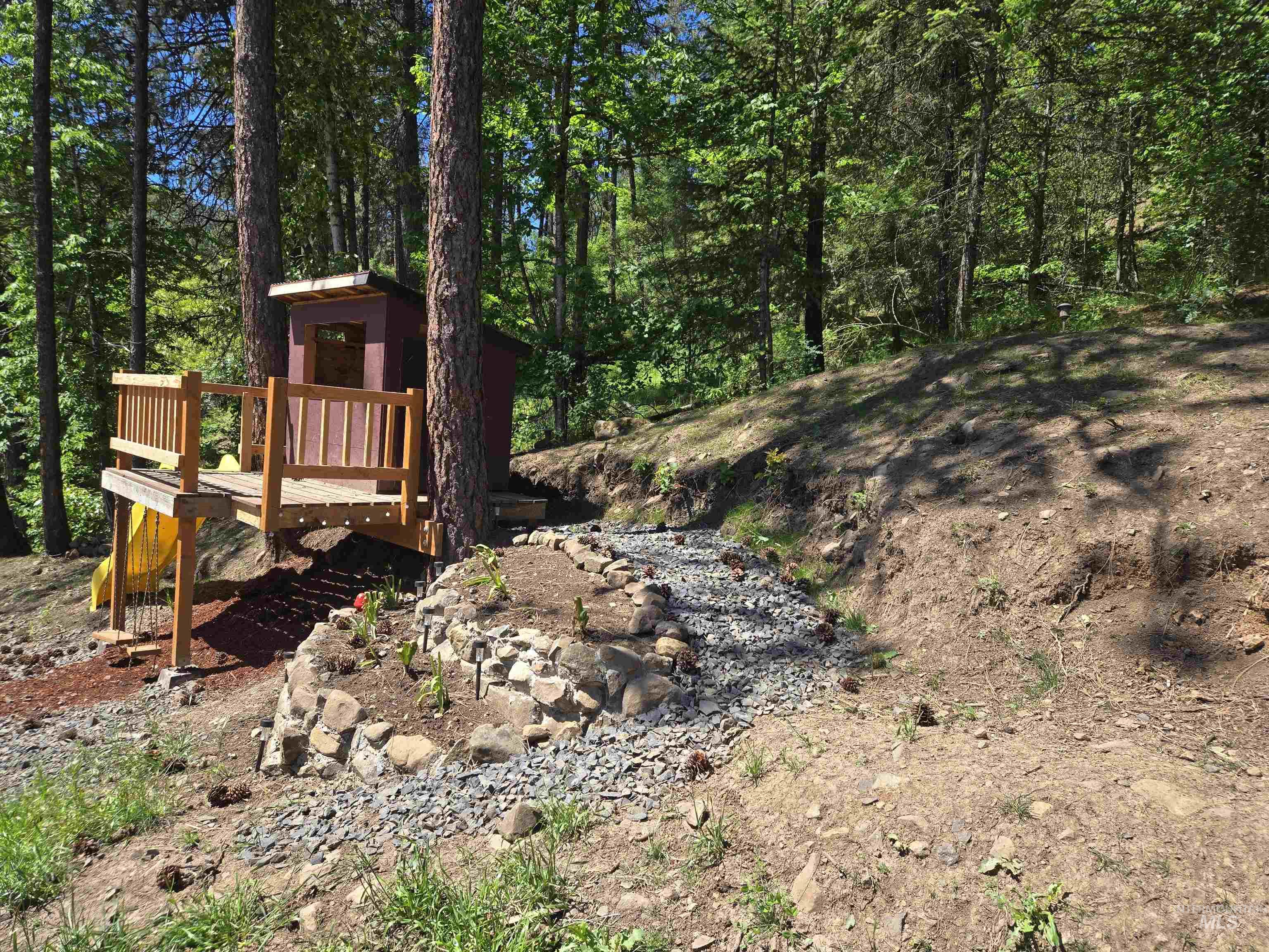 174 Konkolville Road Orofino, ID 83544 - Photo 42 of 43 Elevated wooden deck structure featuring a small enclosed playhouse with a red exterior